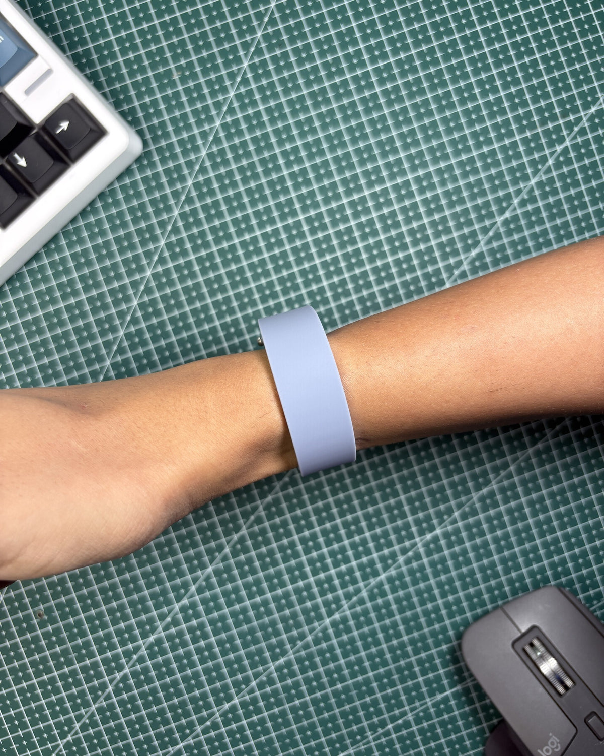 Fitbit Air Elevated Band in Moonstone worn on wrist, top view