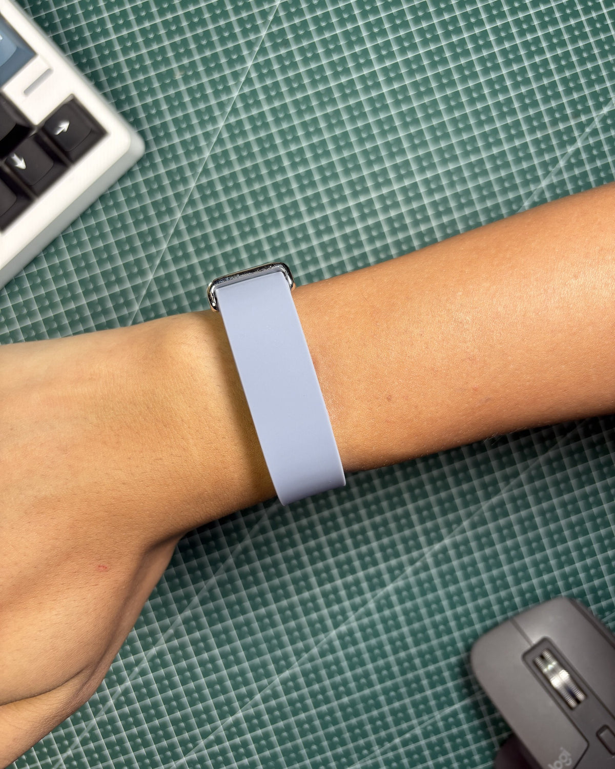 Fitbit Air Elevated Band in Moonstone worn on wrist, stainless steel clasp view