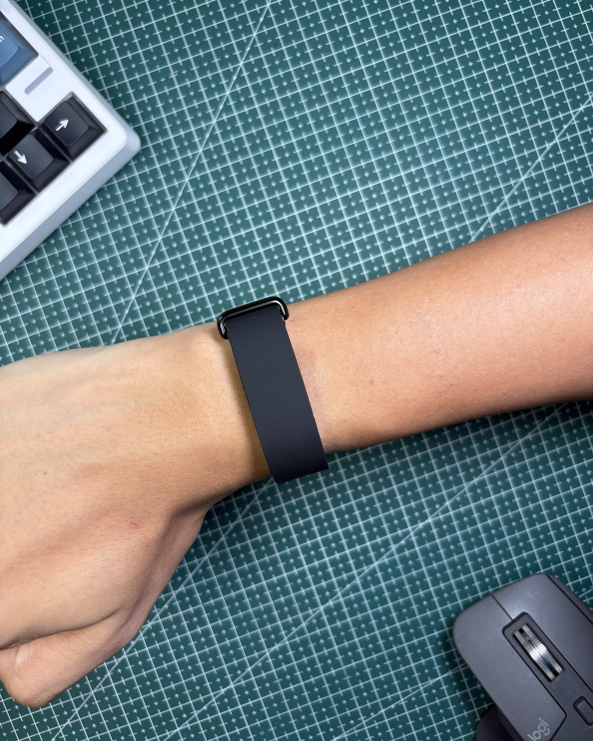Fitbit Air Elevated Band in Obsidian worn on wrist, stainless steel clasp view