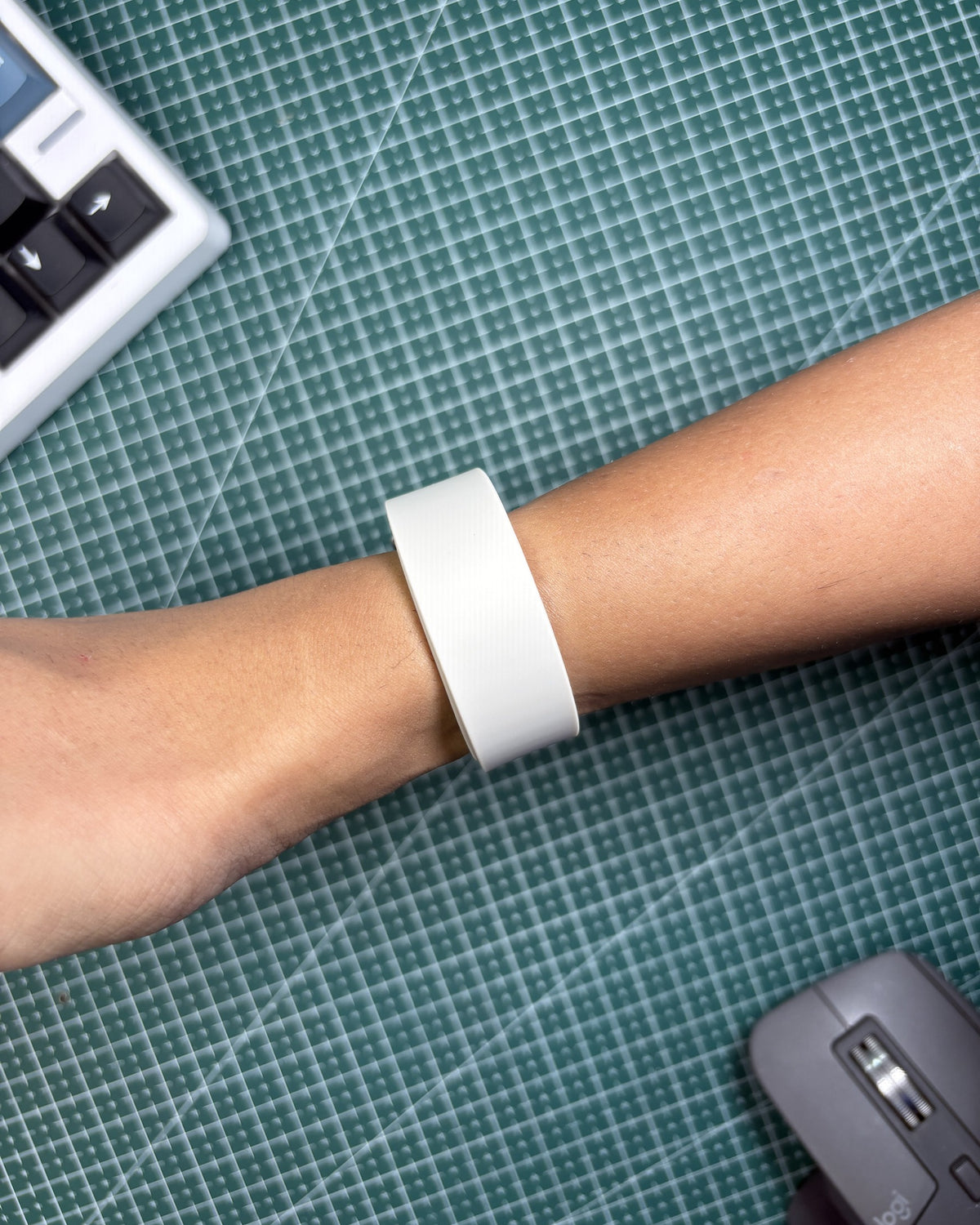 Fitbit Air Elevated Band in Porcelain worn on wrist, top view