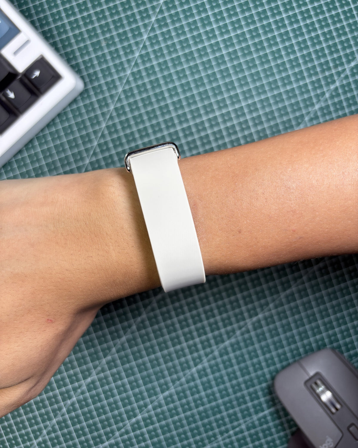 Fitbit Air Elevated Band in Porcelain worn on wrist, stainless steel clasp view