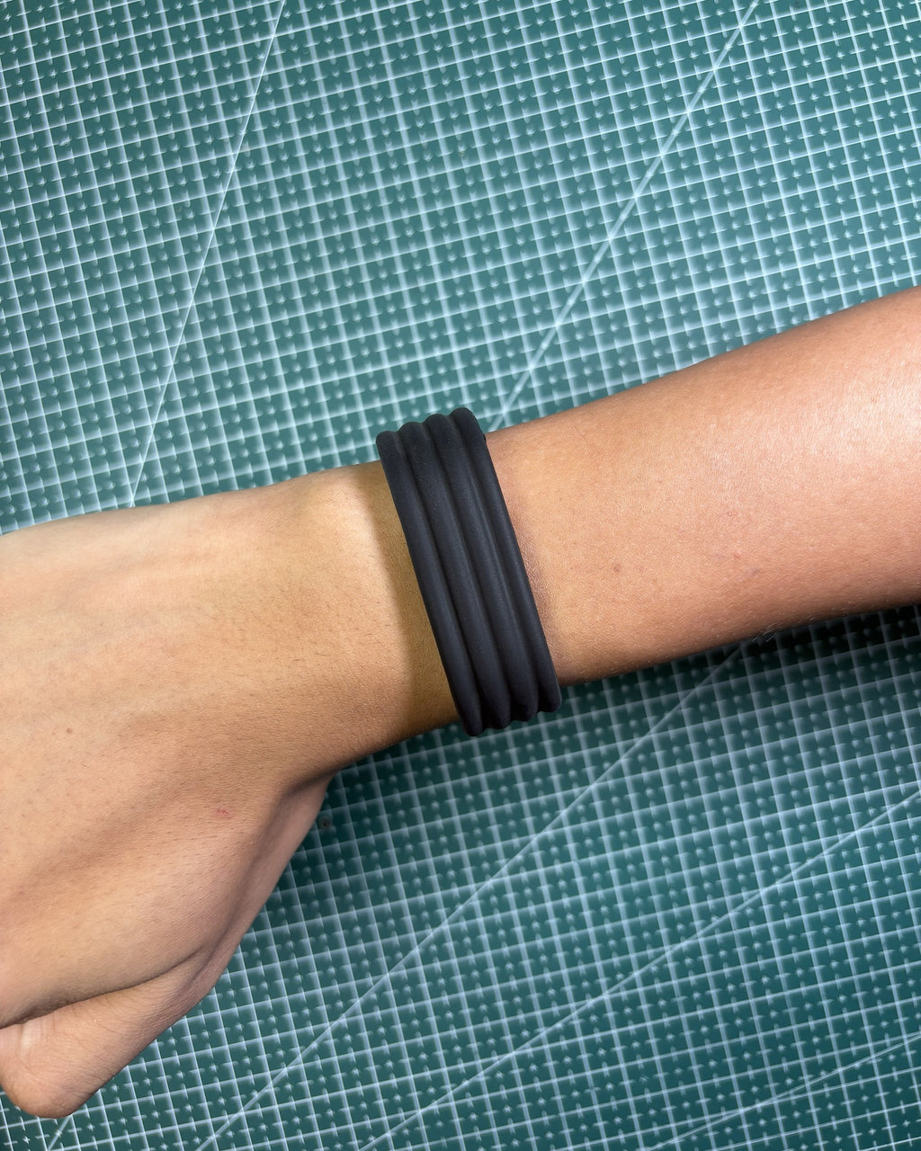 Fitbit Air Silicone Band in Black worn on wrist, top view