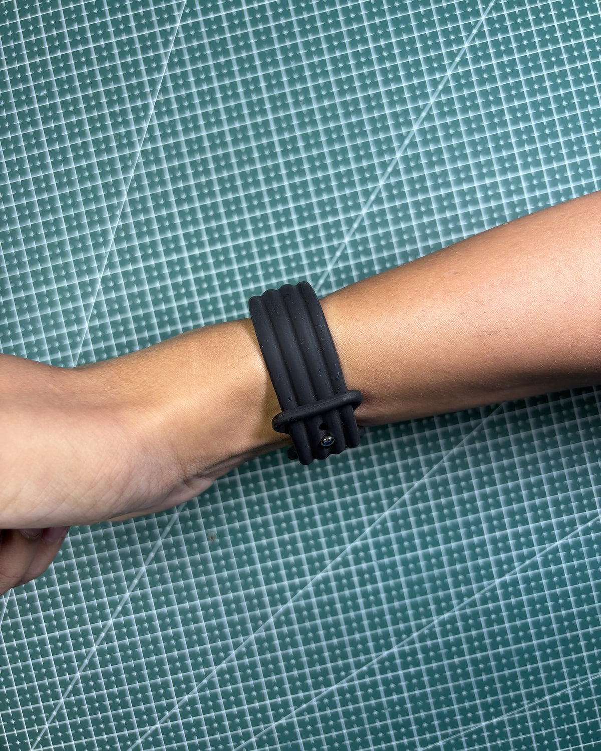 Fitbit Air Silicone Band in Black worn on wrist, clasp view