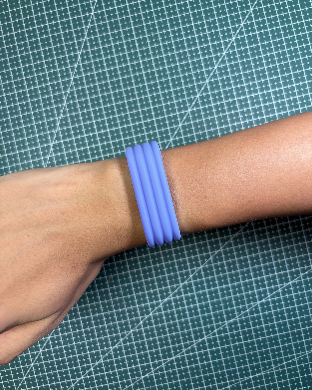 Fitbit Air Silicone Band in Lavender worn on wrist, top view