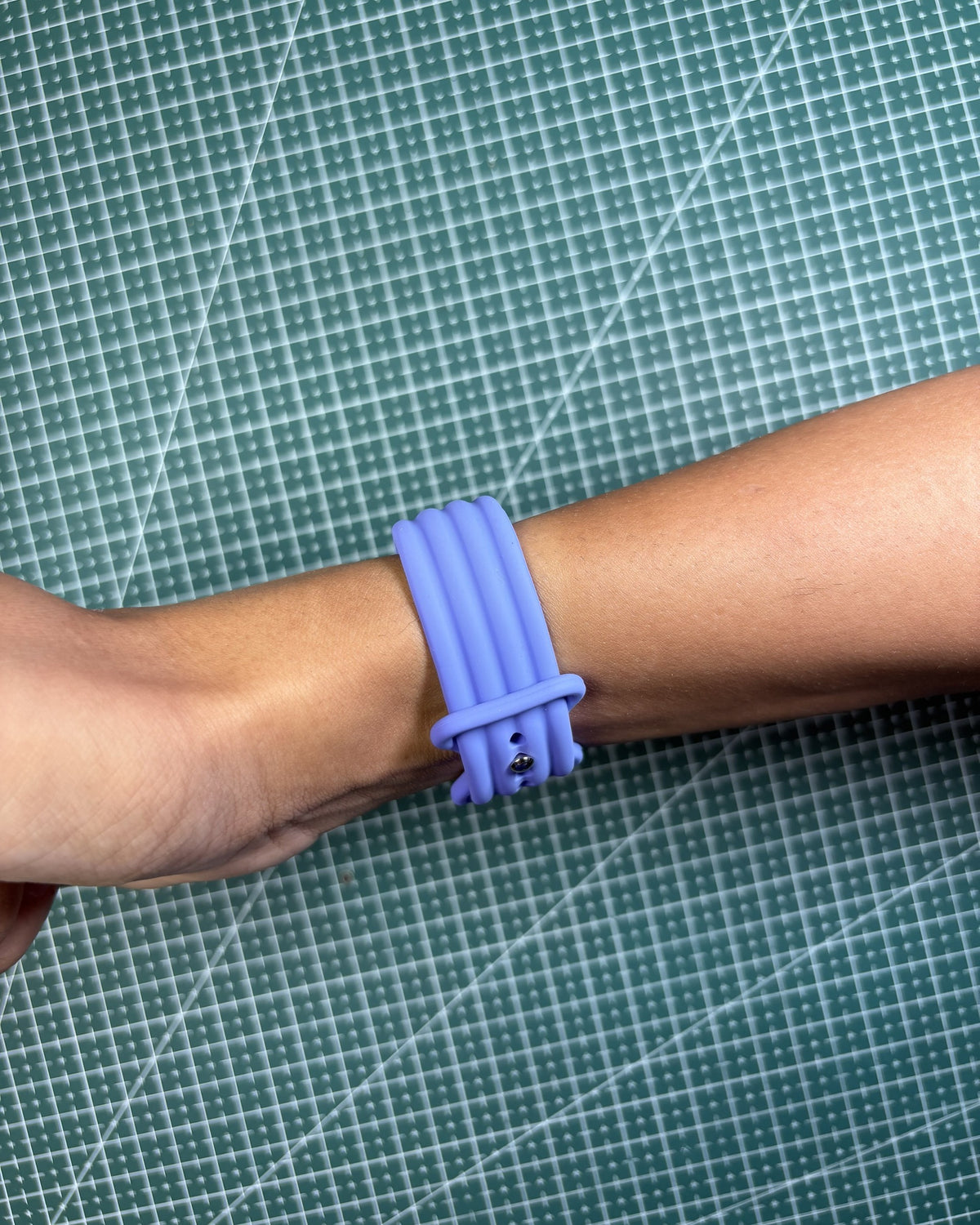 Fitbit Air Silicone Band in Lavender worn on wrist, clasp view