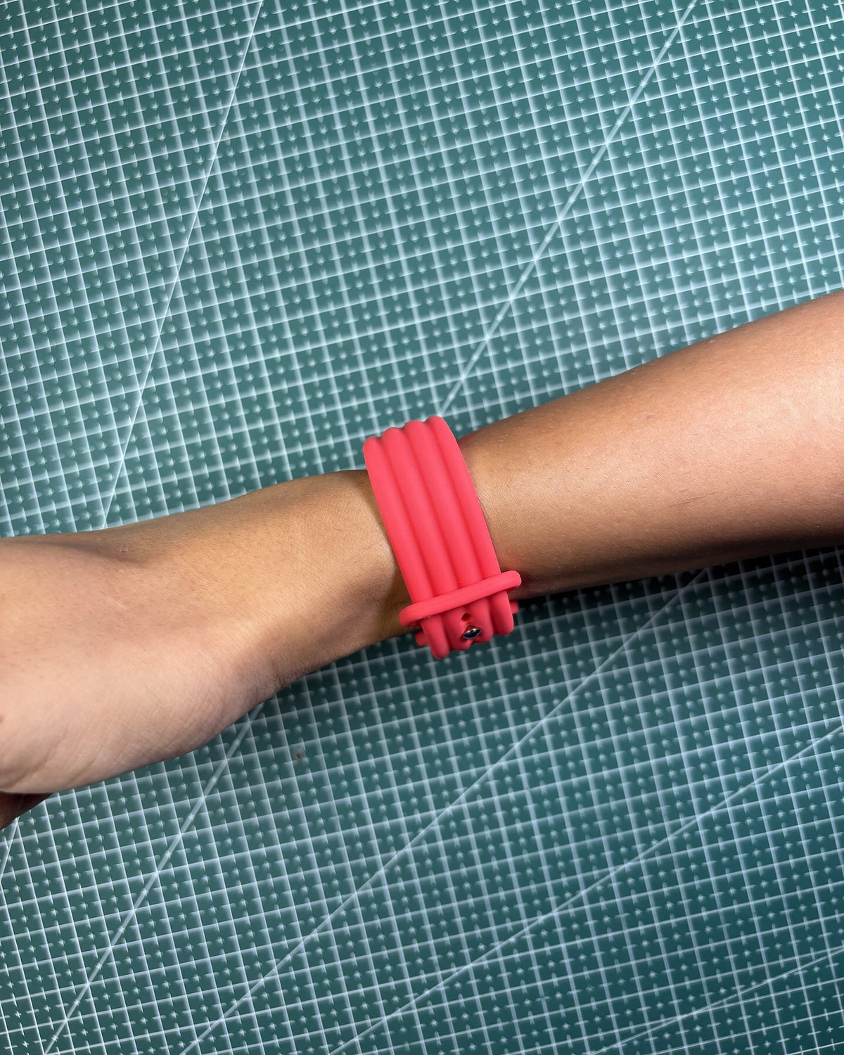 Fitbit Air Silicone Band in Red worn on wrist, clasp view