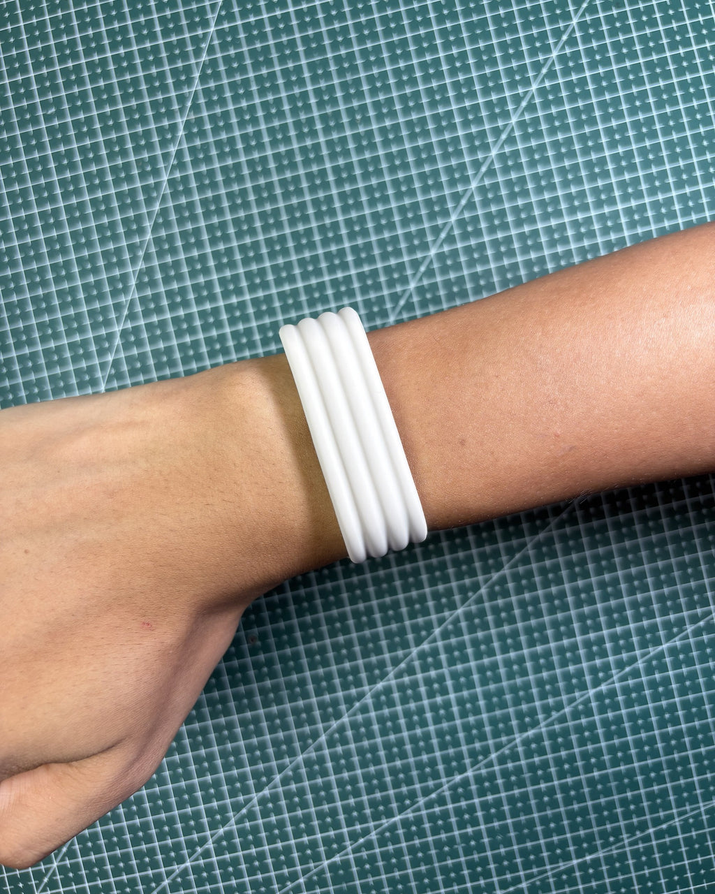 Fitbit Air Silicone Band in Starlight worn on wrist, top view