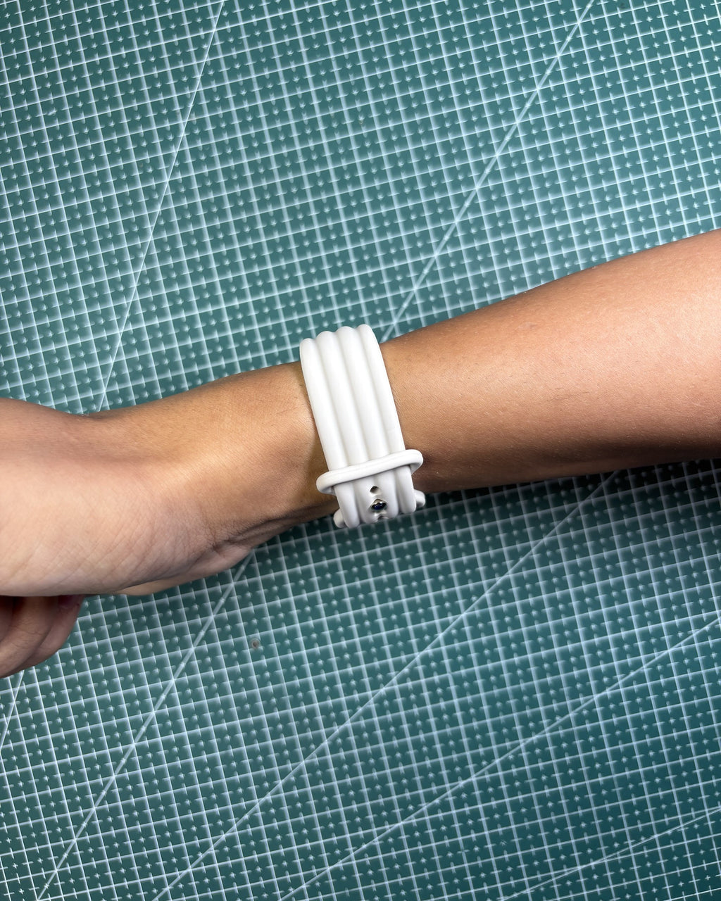 Fitbit Air Silicone Band in Starlight worn on wrist, clasp view